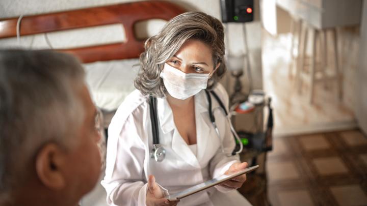 Masked doctor with patient