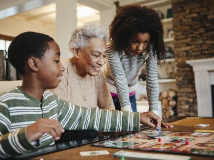An image of three individuals playing a board game