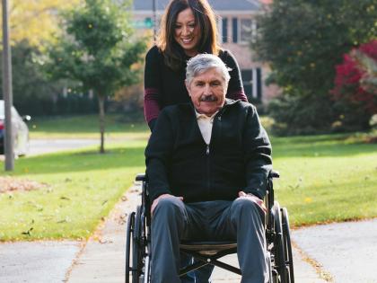 An image of a Family Caregiver with Patient in Wheelchair