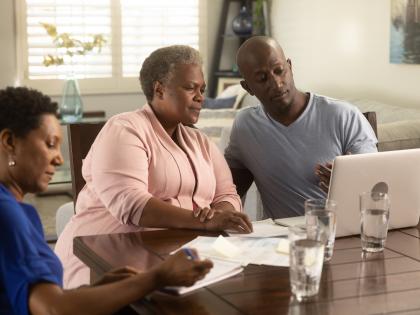 AA Family Looking at Computer