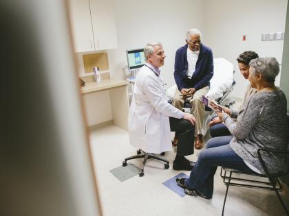 Doctor with patient and family